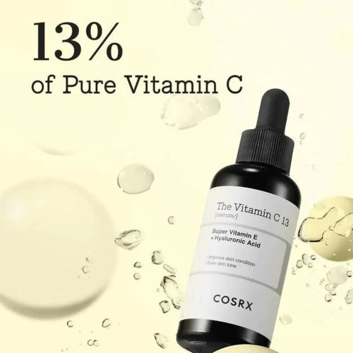 Cosmetolux COSRX The Vitamin C 13 Serum bottle with dropper, featuring bright orange packaging and clear labeling.