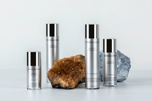 Cosmetolux Vitamin C Serum for sensitive skin in a clear glass bottle with dropper, showing vibrant orange liquid inside.