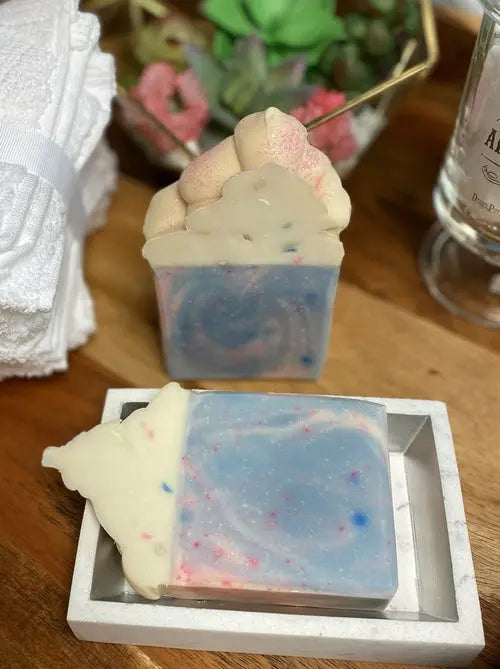 Creamy Cotton Candy Soap by Cosmetolux with a rich lather, displayed in a clear soap dish on a soft background.
