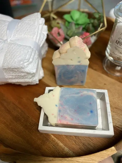 Creamy cotton candy soap by Cosmetolux with lather texture, showcasing a soft pink soap bar on a neutral background.